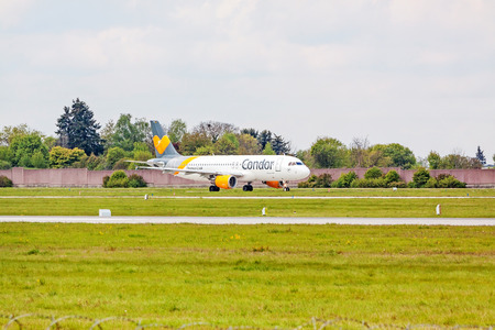 Stuttgart, Germany - April 29, 2017: Airbus airplane A320 from Condor at ground (airport Stuttgart) before take off - green meadow with fence in frontのeditorial素材