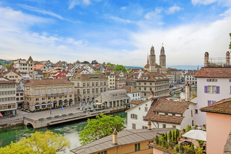 The Grossmunster with town hall, Limmatquai and river Limmat in front. It is a Romanesque-style Protestant church in Zurich, Switzerland. View from park Lindenhof.の写真素材
