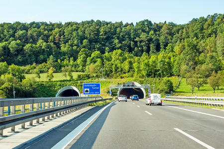cars at tunnel entrance / exit "Schonbuchtunnel" on highway, german autobahnの写真素材