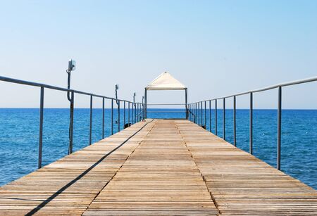 Long Wooden Pontoon Bridge Streaming to the Seaの写真素材