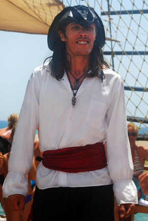 Man Wearing Pirate Costume with Ship Backgroundのeditorial素材