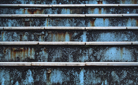 Close-up head-on view of part of a rusty metal blue-painted outdoor staircaseの写真素材