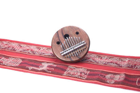 African folk music instrument kalimba on red cloth with white backgroundの写真素材