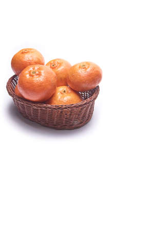 Tangerine basket on white background with space for textの写真素材