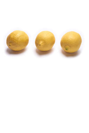 Three lemons on a white background with space for textの写真素材