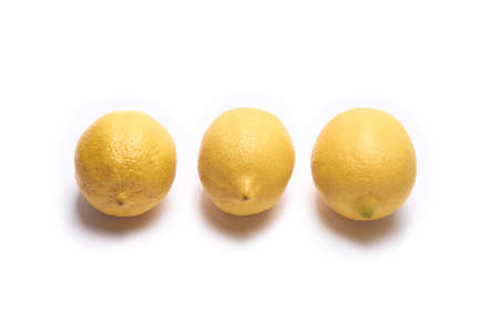 Three lemons on a white background in the centerの写真素材