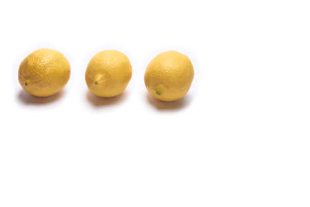 Three lemons on a white background with space for textの写真素材