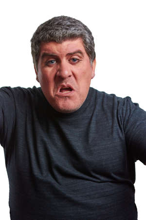 Angry man starting a fight with a black T-shirt on a white backgroundの写真素材