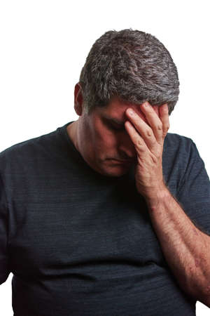 Man with one hand on his head defeated with a black T-shirt on a white backgroundの写真素材