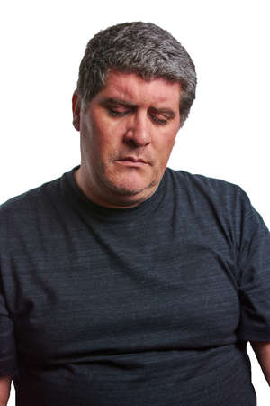 Sad man in a black T-shirt on a white backgroundの写真素材