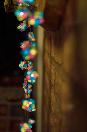 Colorful Christmas lights on a pebble wallの写真素材