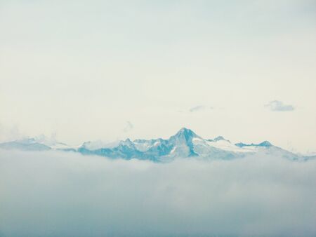 the top of the mountain in the clouds