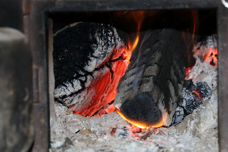 Burning firewood in a fireplace, closeup of photo.