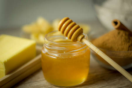 Ingredients for making healthy biscuit. Banana, Oats's Flour, Honey, Cinnamon and Butter on wooden table.の写真素材