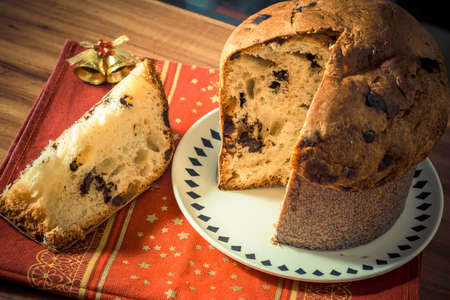 Panettone. Traditional italian dessert for christmas with chistimas light on backgroundの写真素材