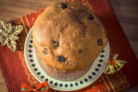 Panettone. Traditional italian dessert for christmas with chistimas light on backgroundの写真素材