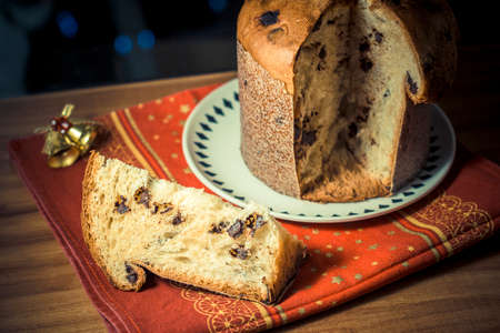Panettone. Traditional italian dessert for christmas with chistimas light on backgroundの写真素材