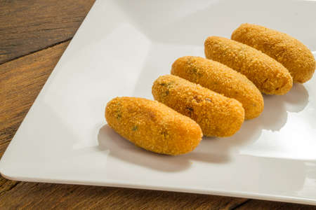 codfish fritters or codfish cakes, a traditional appetizer in Portugal on white backgroundの写真素材