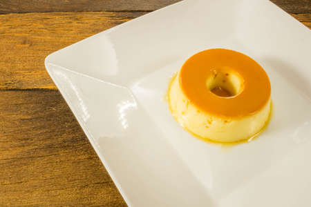 Milk Pudding or Pudim de leite. Brazilian dessert homemade caramel custard pudding. Traditional brazilian flan on wooden backgroundの写真素材