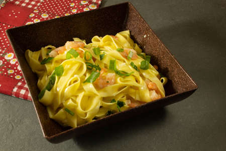 Italian pasta fettuccine with shrimp on a plateの写真素材