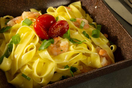 Italian pasta fettuccine with shrimp on a plateの写真素材