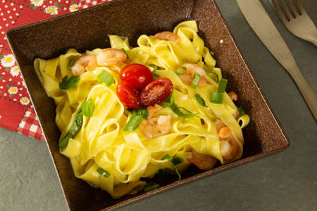 Italian pasta fettuccine with shrimp on a plateの写真素材