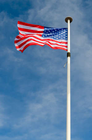 An american flag is floating in a blue skyの写真素材