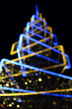 Blurred festive background made with Christmas tree and lights. New year backdrop.の写真素材