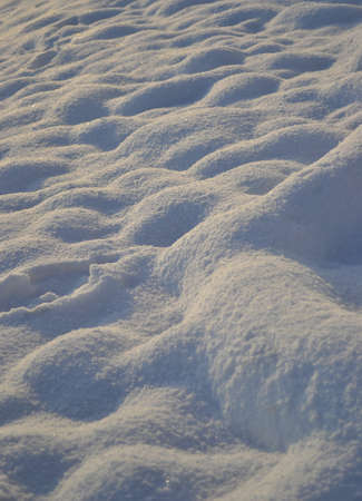Snow dunes texture at sunsetの写真素材