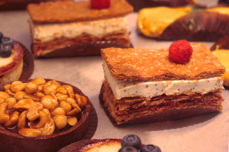 A piece of chocolate cake on a table. High quality photo. Layout with sweet desserts. DIY confectionery. Cake with berries on a table. Photo for bakery. Bekery productsの写真素材