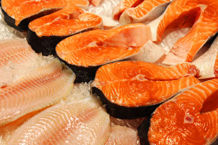 A group of oranges on a table. High quality photo. High quality photo. Salmon steak on the counter...