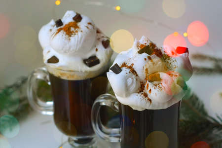 Christmas hot dtinks. New Year layout with a garland and mulled wine. Hot chocolate with cream. Christmas atmospere. High quality photoの写真素材