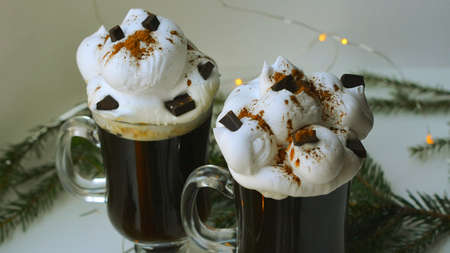 Christmas hot dtinks. New Year layout with a garland and mulled wine. Hot chocolate with cream. Christmas atmospere. High quality photoの写真素材
