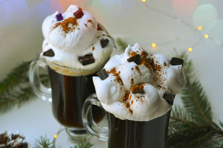 Christmas hot dtinks. New Year layout with a garland and mulled wine. Hot chocolate with cream. Christmas atmospere. High quality photoの写真素材