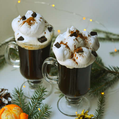 Christmas hot dtinks. New Year layout with a garland and mulled wine. Hot chocolate with cream. Christmas atmospere. High quality photoの写真素材