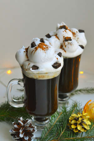 Christmas hot dtinks. New Year layout with a garland and mulled wine. Hot chocolate with cream. Christmas atmospere.の写真素材