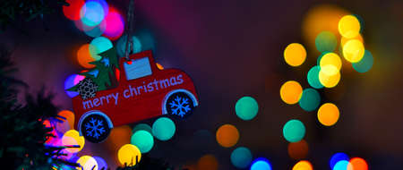 Christmas toy on the Christmas tree. New Years background with a place for text. New Years Eve 2022. Christmas background with bright bokeh.の写真素材