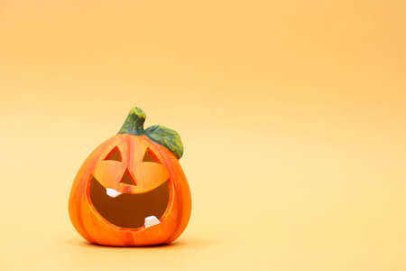 Cheerful halloween pumpkin on an orange background. Halloween background with place for text. Nhe day of the Dead. Autumn holidayの写真素材