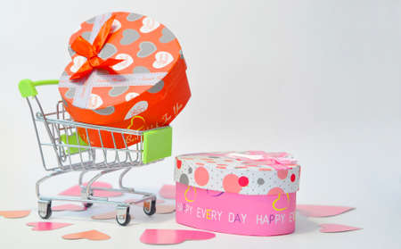 Buying gifts for Valentines Day. Valentines Day. Trolley with gifts on a white background. Layout...