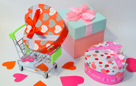 Buying gifts for Valentines Day. Valentines Day. Trolley with gifts on a white background. Layout with gifts for Valentines Day. Valentines day shoppingの写真素材