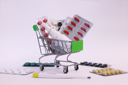 A supermarket trolley full of blister pills, a lot of pills in a wheelbarrow. Concept: home delivery of medicines.Empty space, a place for text, poster, board. Medical blue background.の写真素材