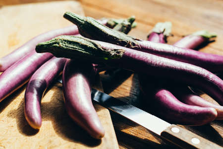 smart purple eggplants on the table , in kitchen, ready to be cookedの写真素材