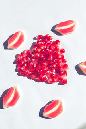 heart of vibrant pomegranate on white background, minimal pop conceptの写真素材