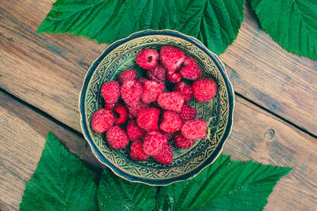 raspberries ceramic wood leaf summer berry sweetの写真素材