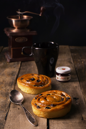 Coffee with Sinamon Buns and berry jamの写真素材