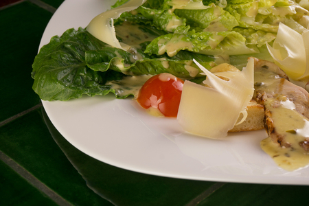 Caesar salad on a green backgroundの写真素材