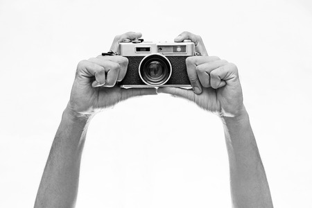 Two hand holding a vintage camera  isolated on white backgroundの写真素材