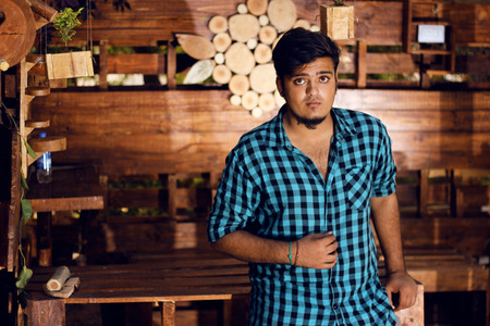 Handsome fashion man wearing shirt, Posing in woodsの写真素材