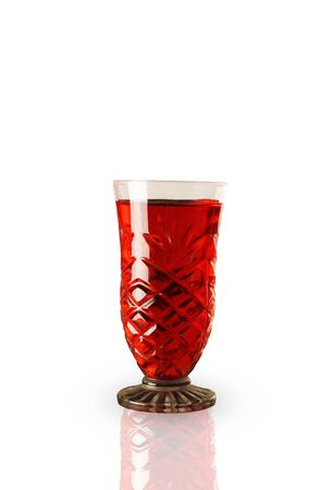 Red sweet refreshing drink in a glass, isolated on whiteの写真素材