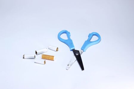 Scissor cutting cigarette isolated on white backgroundの写真素材